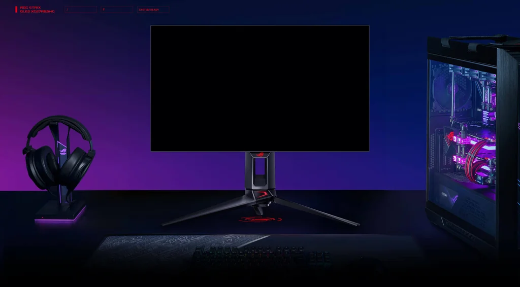 Modernes Gaming-Setup mit ROG Strix OLED-Monitor, RGB-beleuchtetem PC und Zubehör – ideal zum Zocken, Streamen und kreativen Arbeiten.